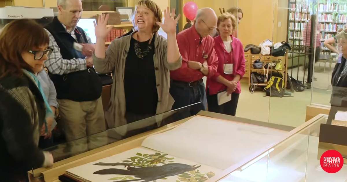 Hundreds cram into a tiny library in Maine to watch two people turn one page every year since 2016