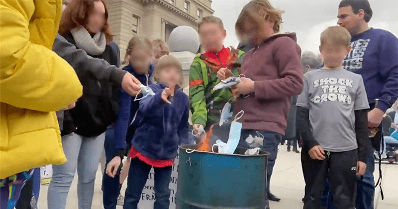 'Here fire, you hungry?' Anti-maskers encourage children to burn masks during Idaho protest