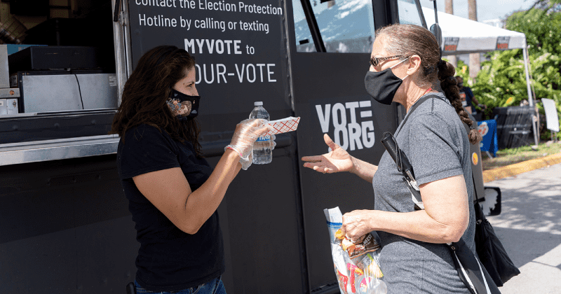 It's now illegal to give food, water to voters standing in line, in Georgia