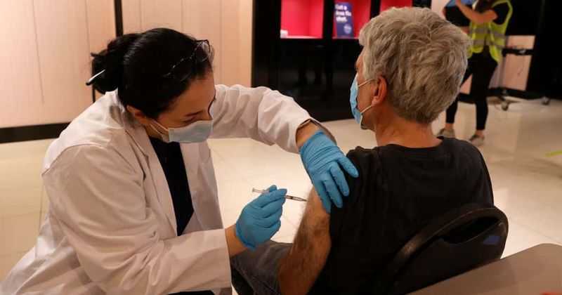 After surviving COVID-19, a 71-year-old 'strong conservative' is getting vaccinated. But he's losing friends.