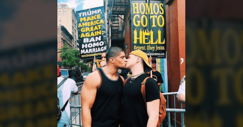 Openly gay pro wrestler kisses boyfriend in front of homophobic protesters in epic photo