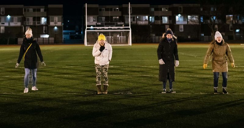 A group of exhausted mothers gathered on a field to scream amid pandemic struggles and frustrations