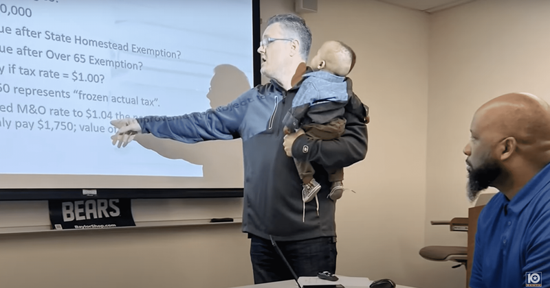 Professor graciously holds doctoral candidate's foster baby during class so she can take notes