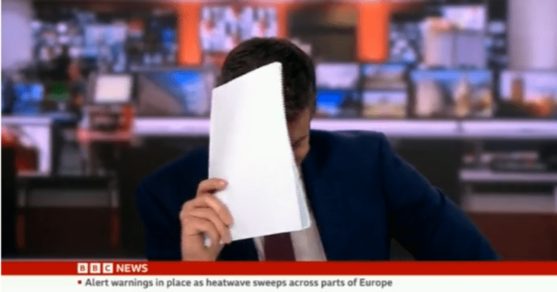 BBC news anchor scared of snakes hilariously hides face while reporting on a story about a serpent