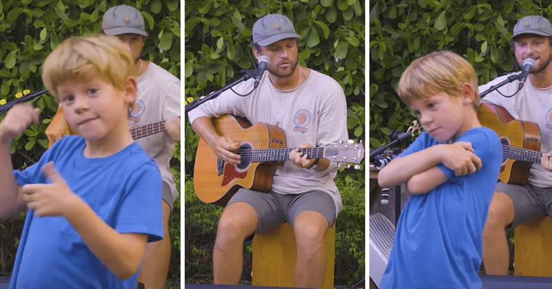 Little boy confidently vibes to musician's upbeat song at a restaurant and it is a whole mood