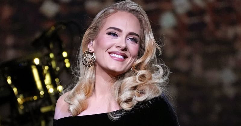 Adele gets emotional and pauses show to hug doctor who delivered her baby after spotting him in crowd