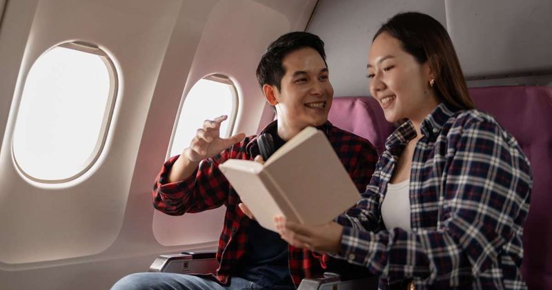 A fan was busy reading a novel on the flight — he had no idea the author was sitting right beside him