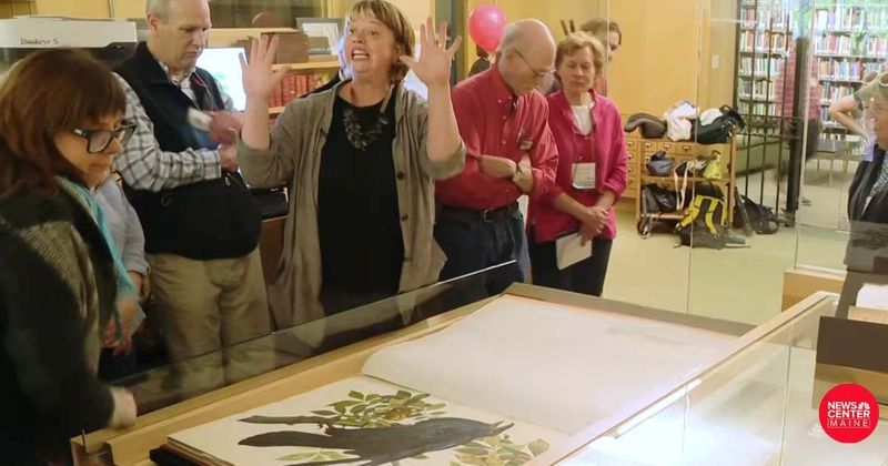 Hundreds cram into a tiny library in Maine to watch two people turn one page every year since 2016