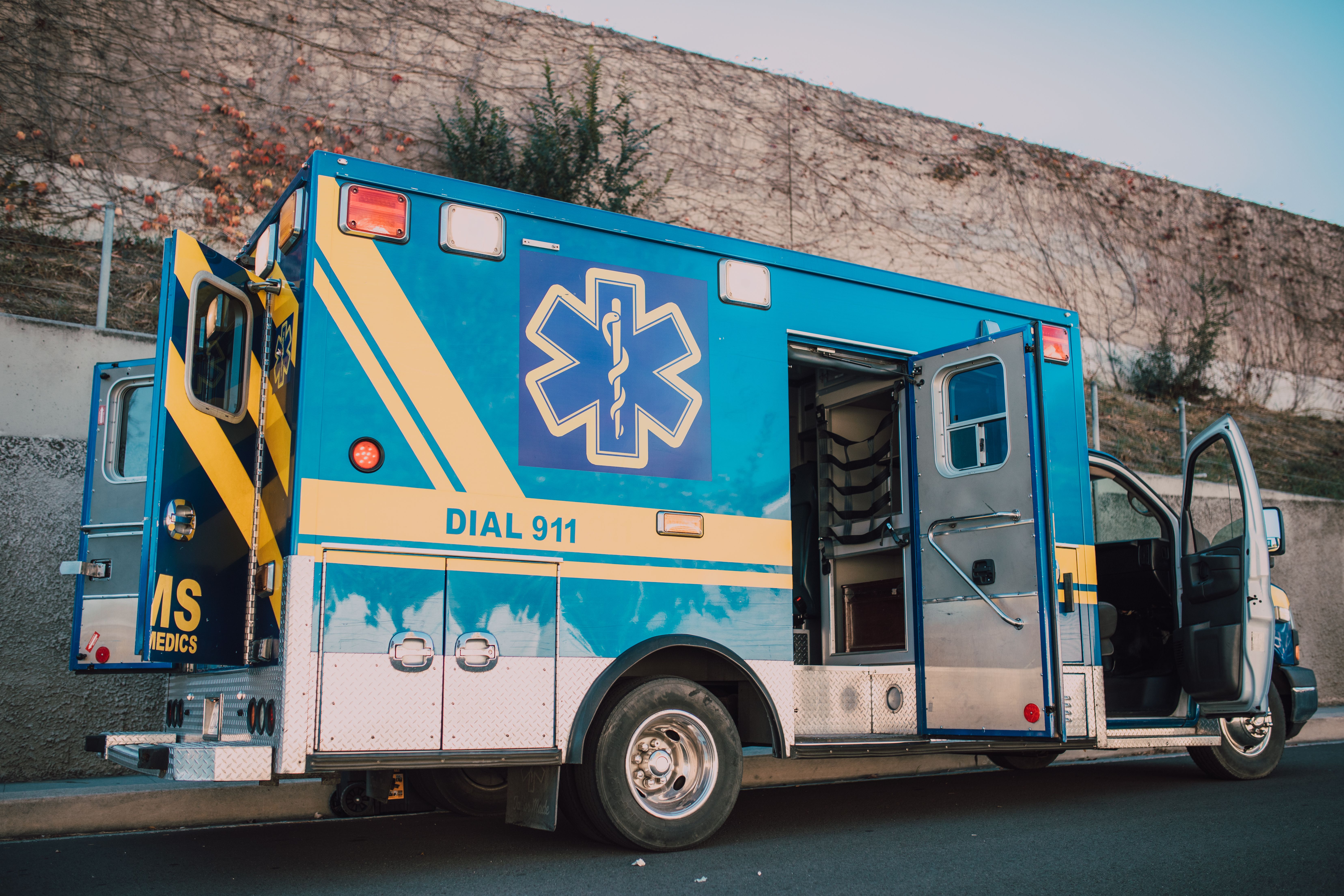 The blue ambulance is parked on the roadside with open doors. (Representative Cover Image Source: Pexels | Photo by RDNE Stock project)