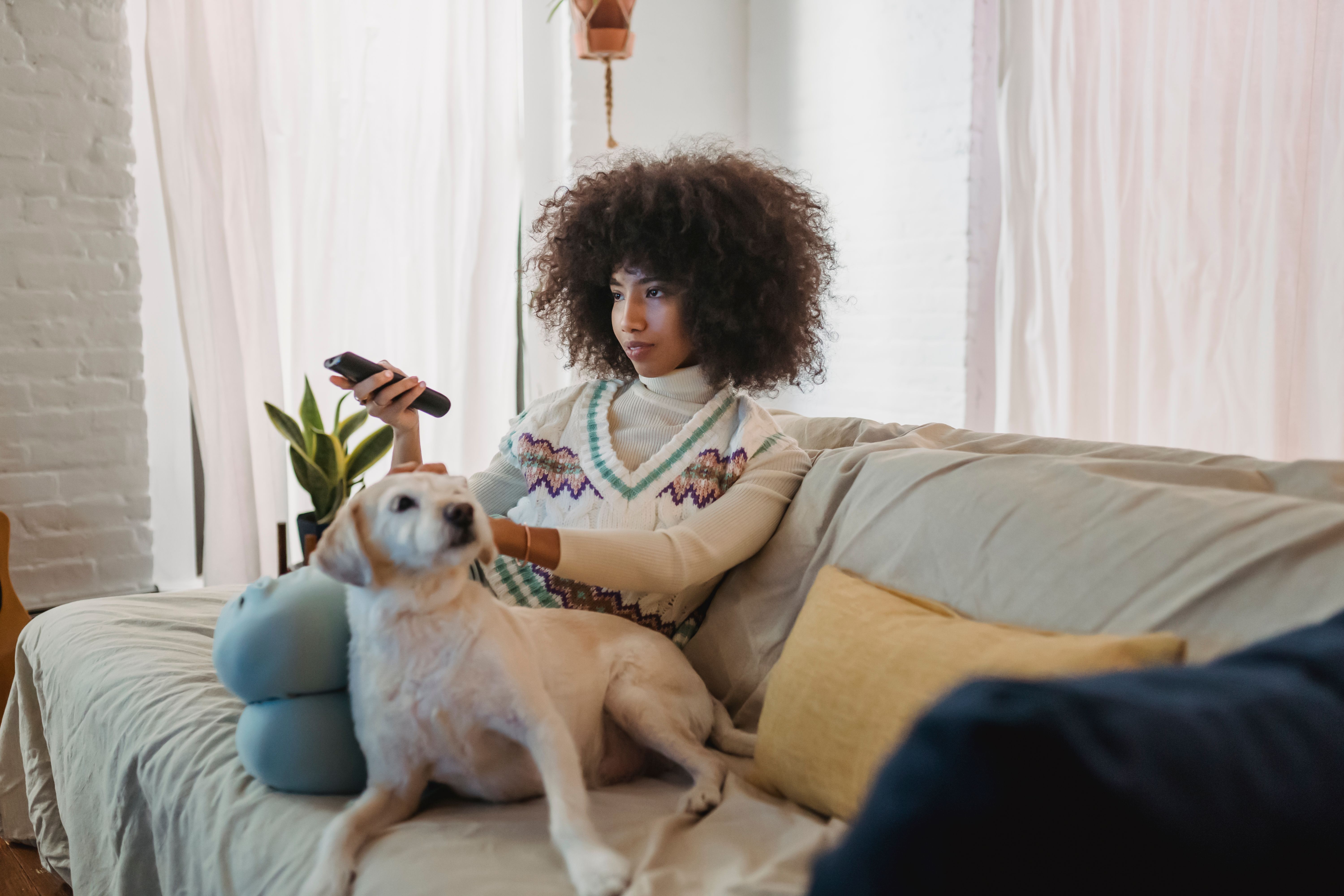 Woman watching TV with her dog.