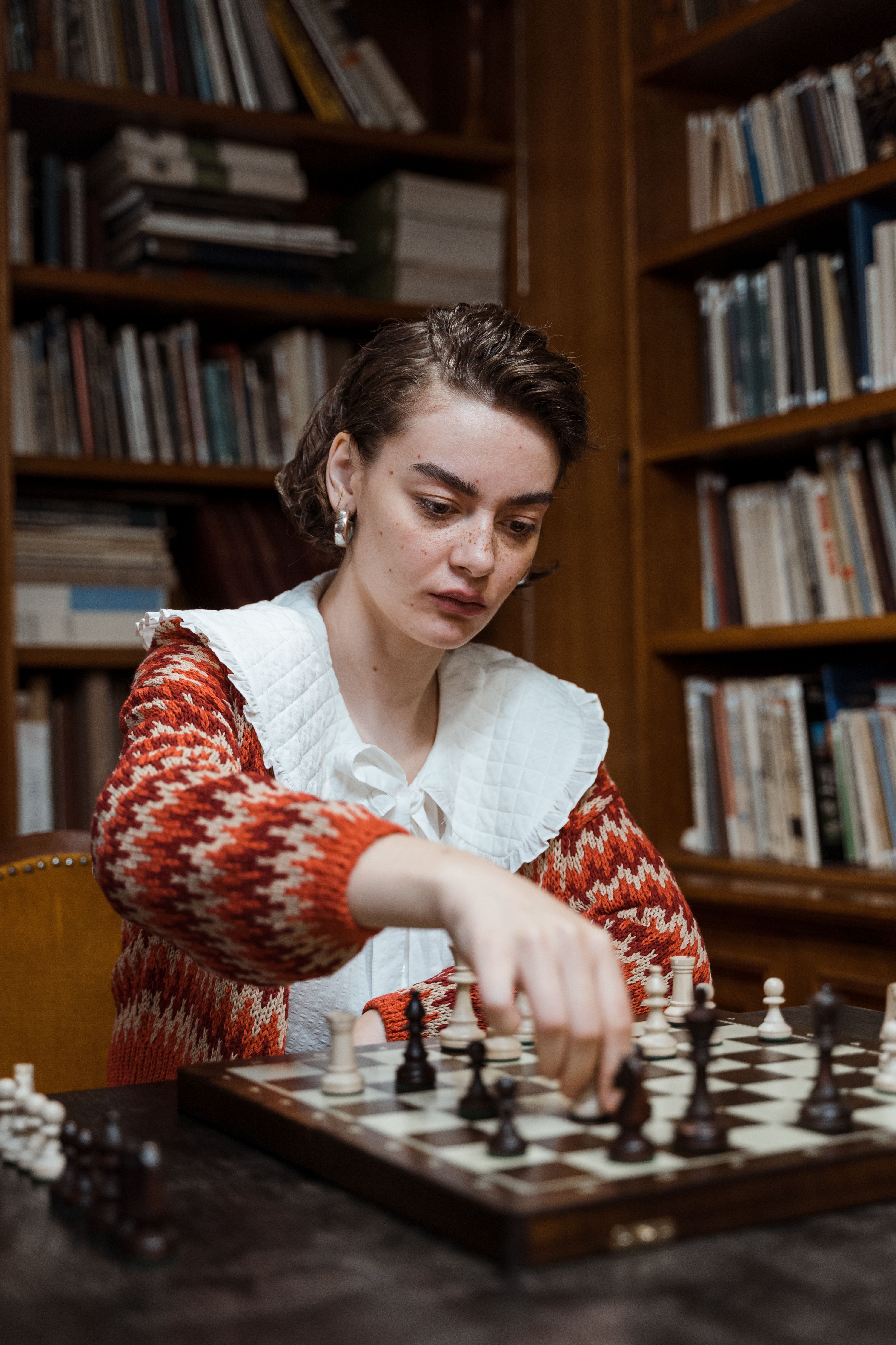 A woman concentrating on a chess game. (Representative Cover Image Source: Pexels | Photo by Tima Miroshnichenko)