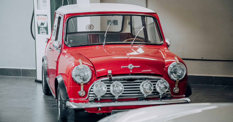A classic red Mini Cooper displayed indoors, exuding vintage charm and retro style (Representative Image Source: Pexels | Photo by Amar Preciado)