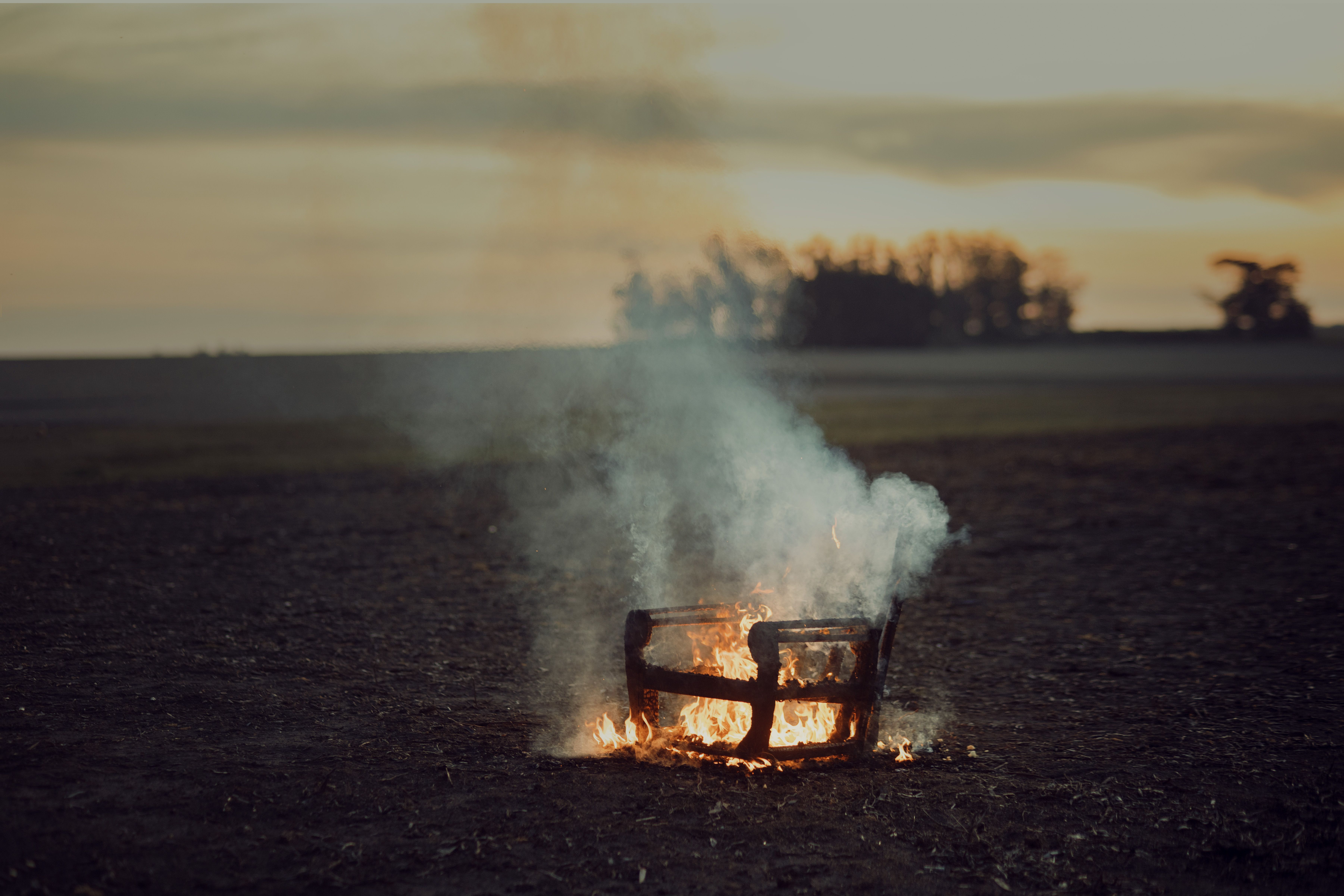 A chair burning with billowing smoke and embers. (Representative Image Source: Pexels | Photo by )
