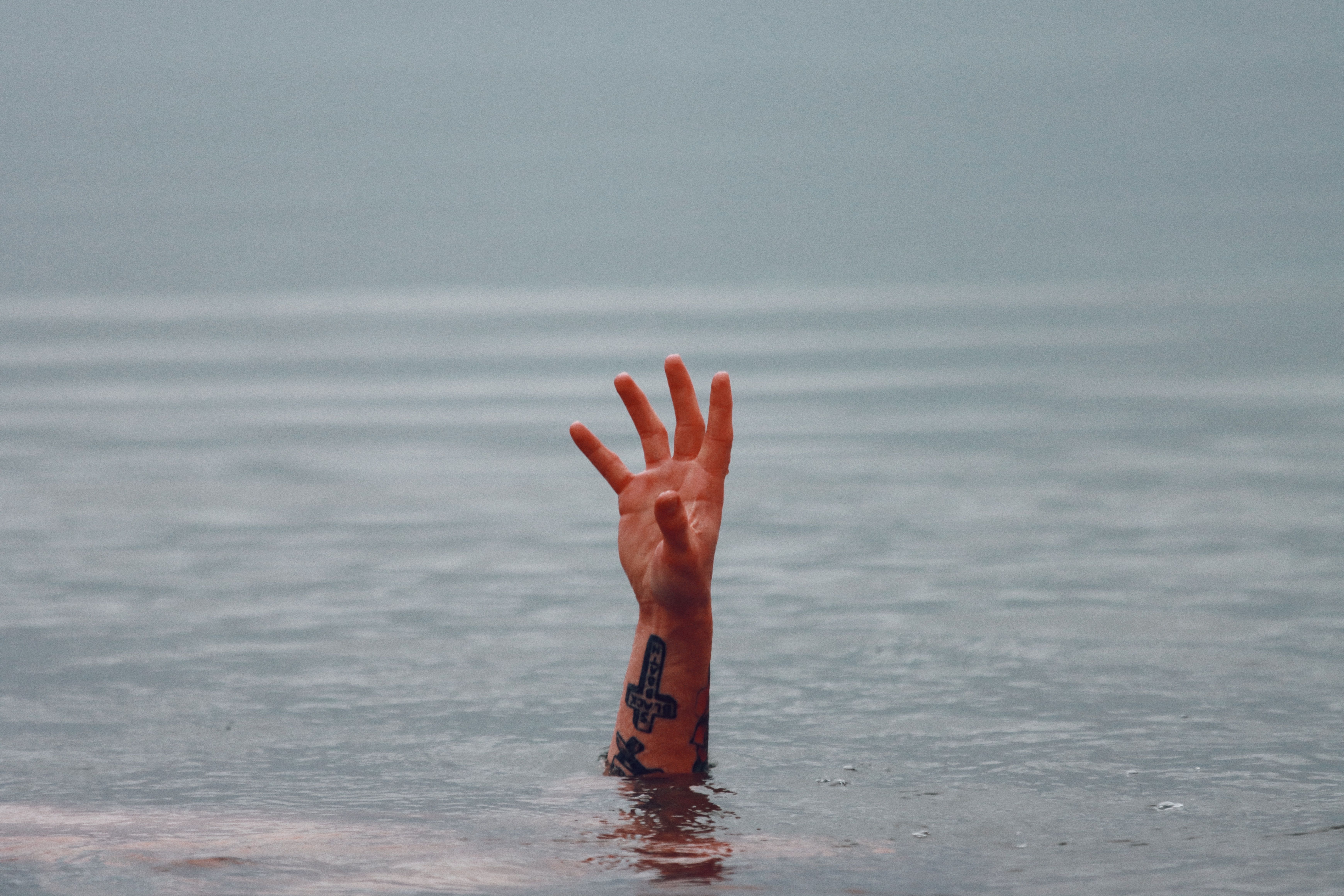 Hand of a drowning man sticking out of the water in a river (Representative Image Source: Pexels | Photo by Efrem Efre)