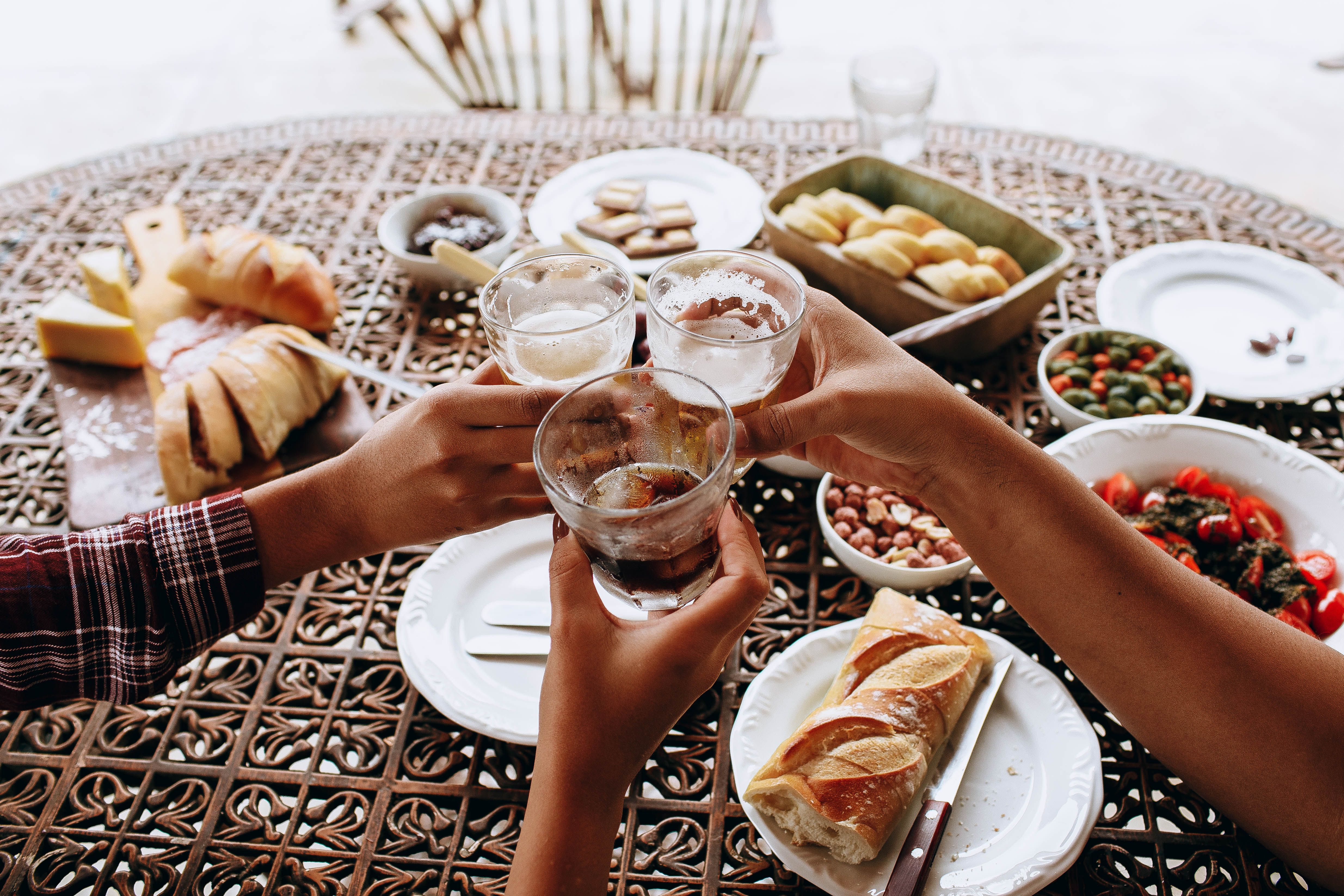 A lavish platter of meals laid out on a restaurant table and a customer enjoying it (Representative Image Source: Pexels | Photo by Helena Lopes)