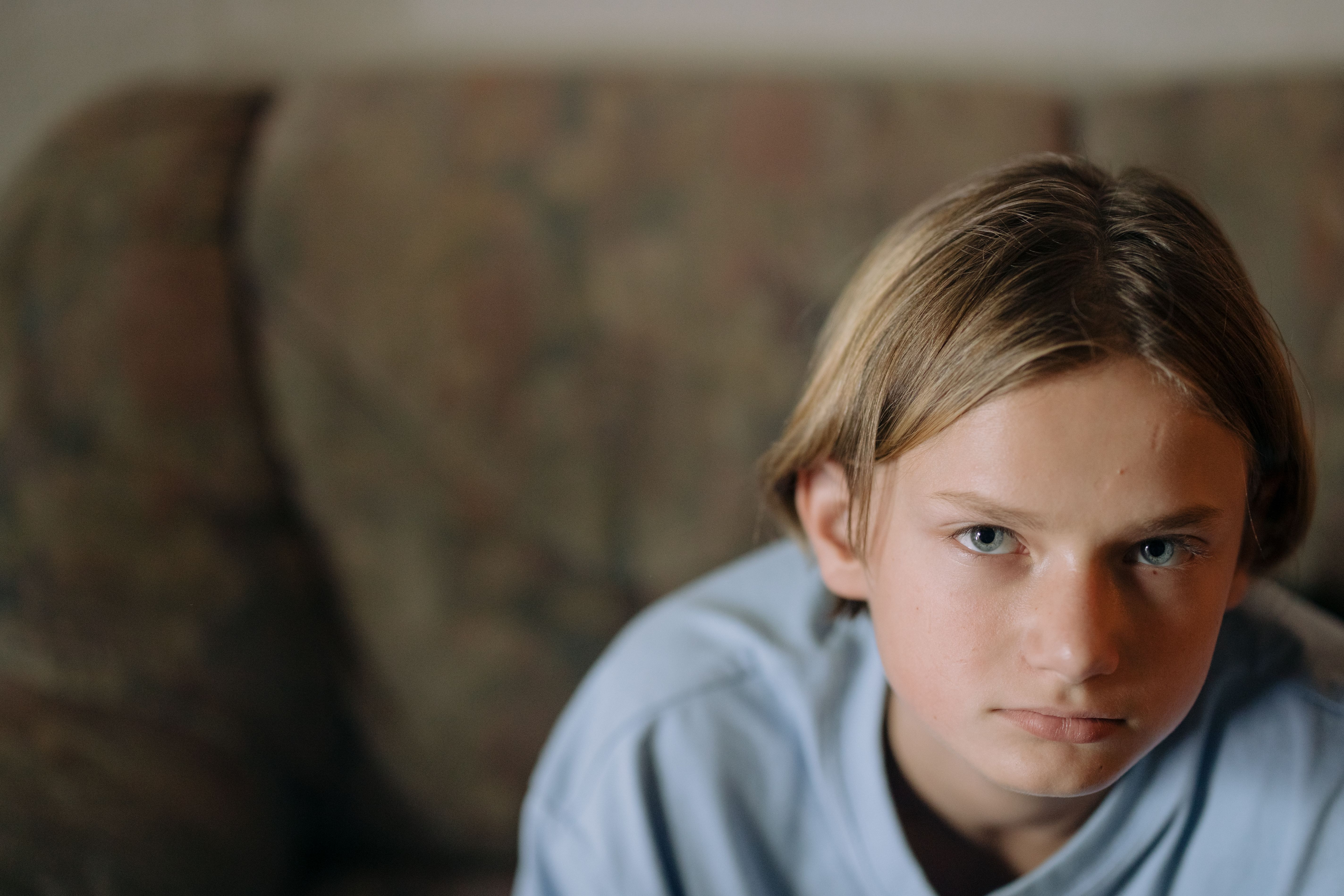 Close-up portrait of a serious teenage boy in a home. (Representative Cover Image Source: Pexels | Photo by cottonbro studio)