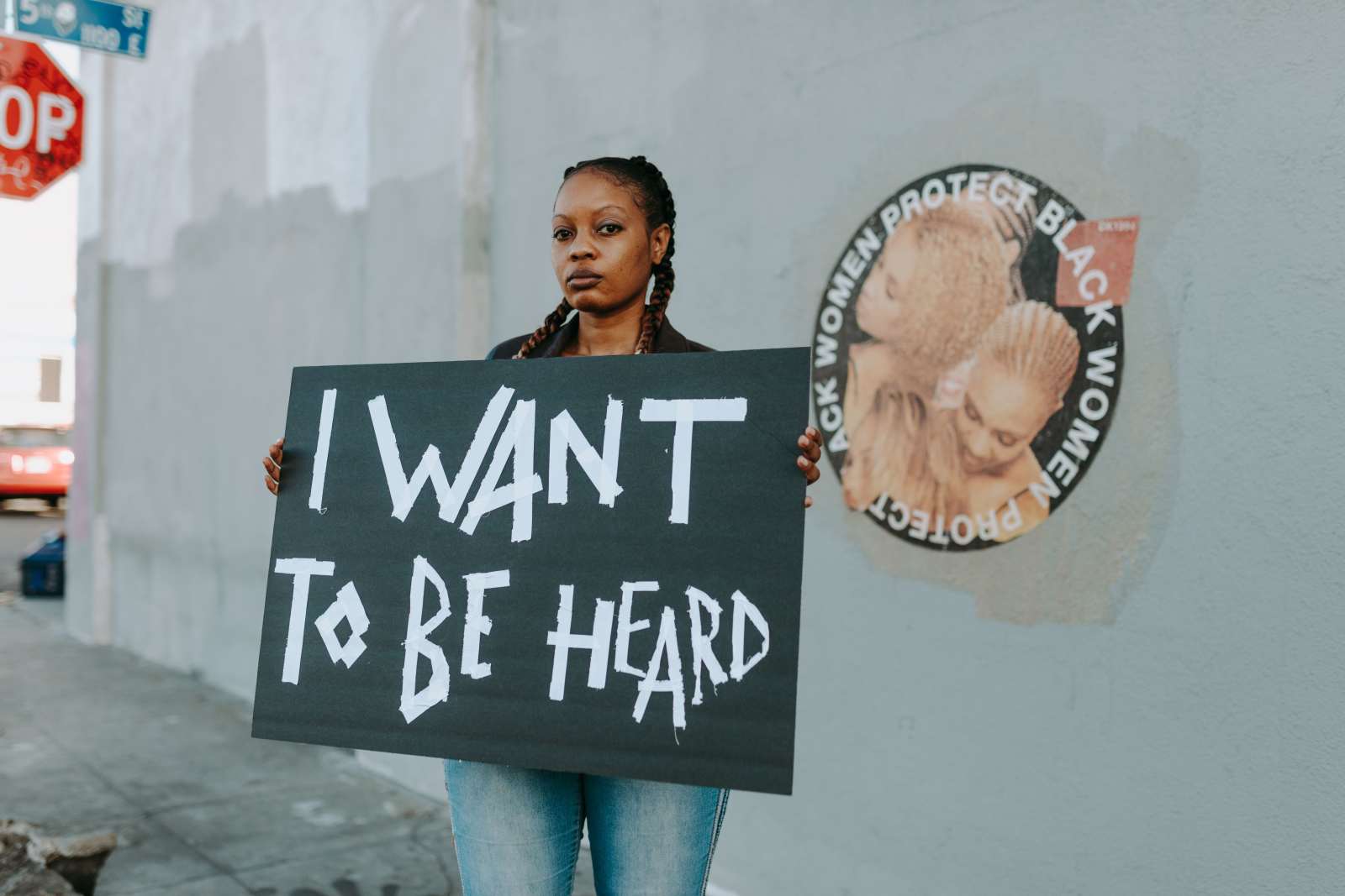 Woman with a banner pleading for support (Representative Image Source: Pexels | Photo by RDNE Stock Project)