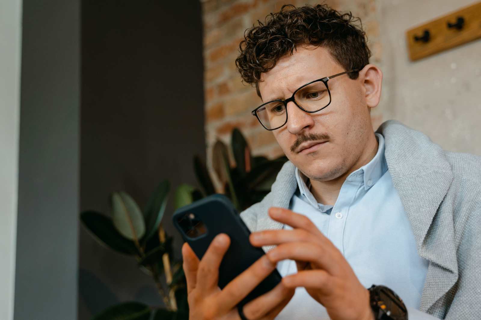 Man looking at phone with a serious expression (Representative Image Source: Pexels | )