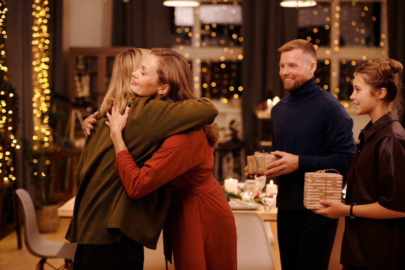 Woman hugging family members (Representative Image Source: Pexels | Photo by Nicole Michalou)