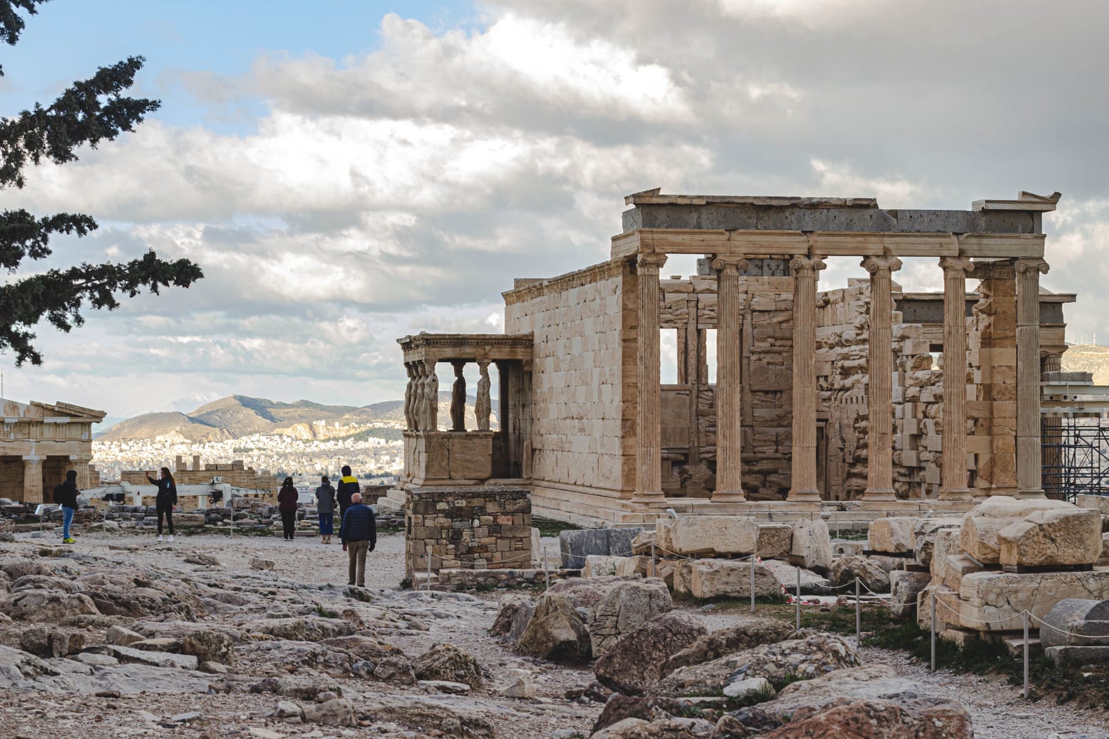 View of the ancient Erechtheion temple in Athens with people exploring the site. (Representative Image Source: Pexels | Photo by Leandro Paes Leme)