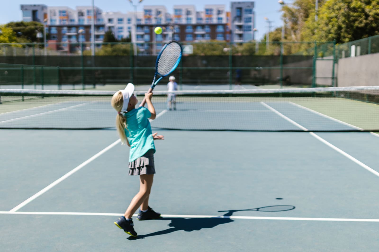A girl in sportswear hitting a tennis ball on a sunny outdoor court. (Representative Cover Image Source: Pexels | Photo by RDNE Stock Project)