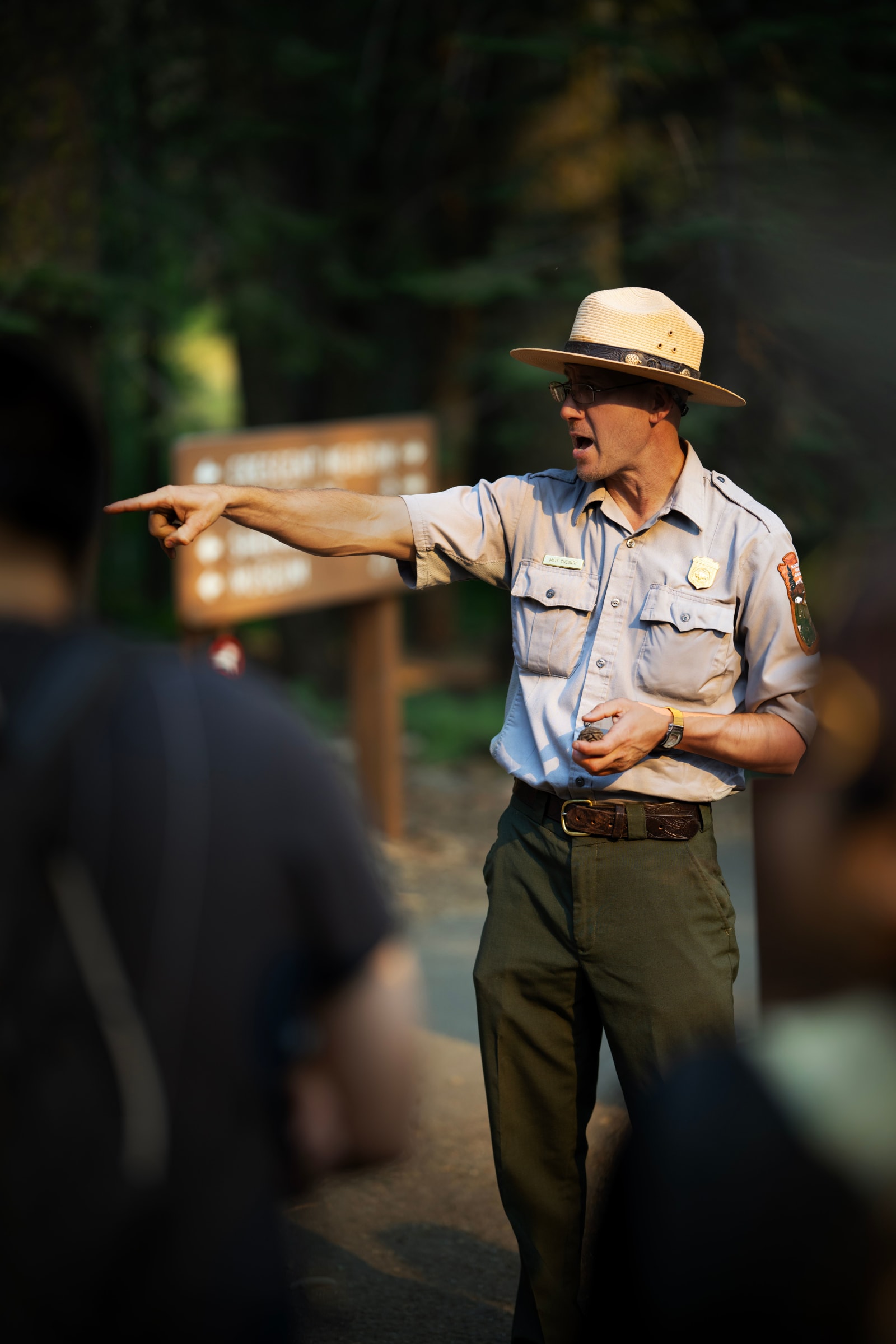 A park ranger pointing at something.