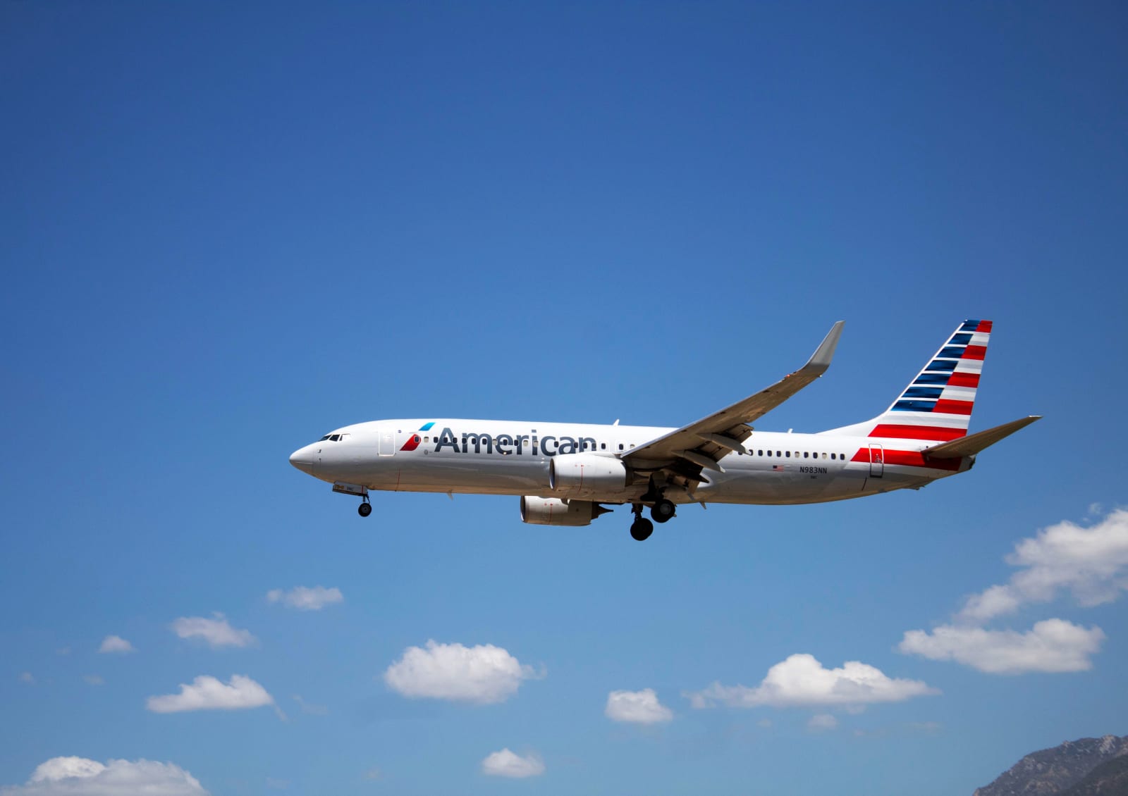 An American Airlines plane flying through a clear blue sky. (Representative Image Source: Pexels | Photo by Fernanda)