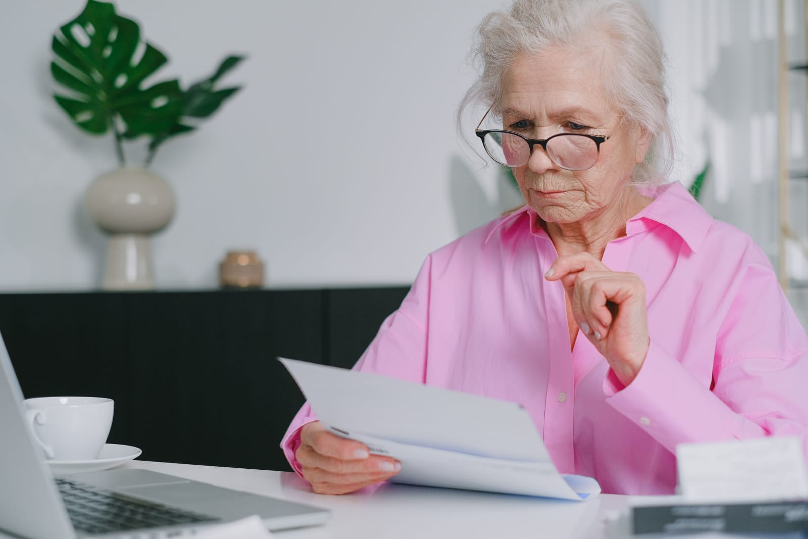 Old woman in pink dress filing taxes (Representative Image Source: Pexels | Photo by SHVETS Production)