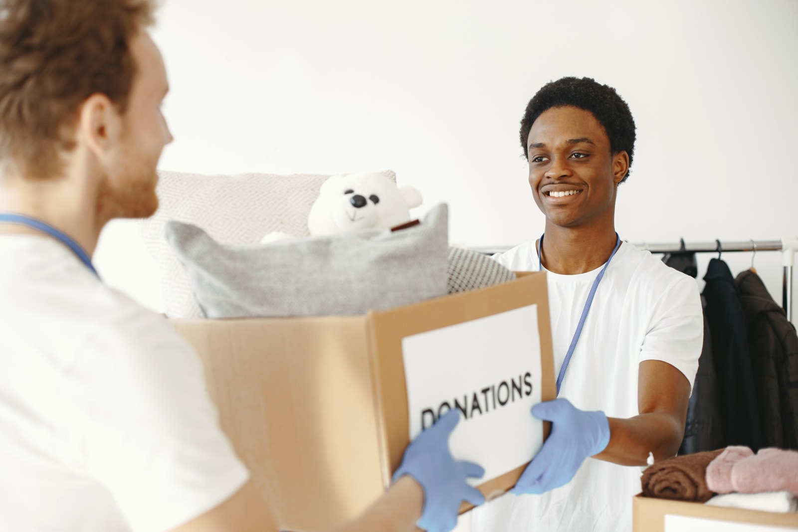 Man extending a box of donation towards another man (Representative Image Source: Pexels | )
