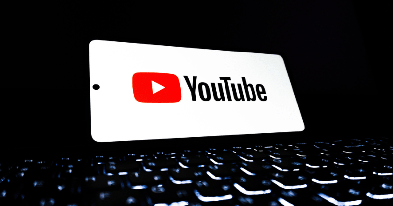 YouTube app icon displayed on a smartphone (Representative Image Source: Pexels | Photo by Zulfugar Karimov)