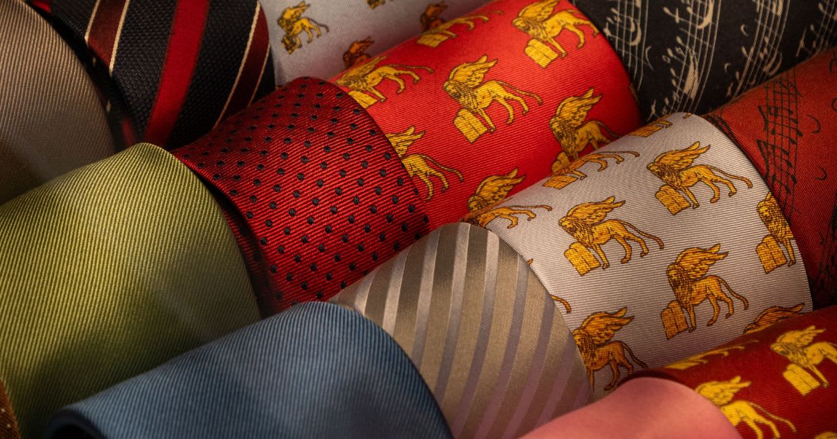 A collection of colorful patterned neckties neatly arranged in rows. (Representative Image Source: Pexels | Photo by Fer ID)
