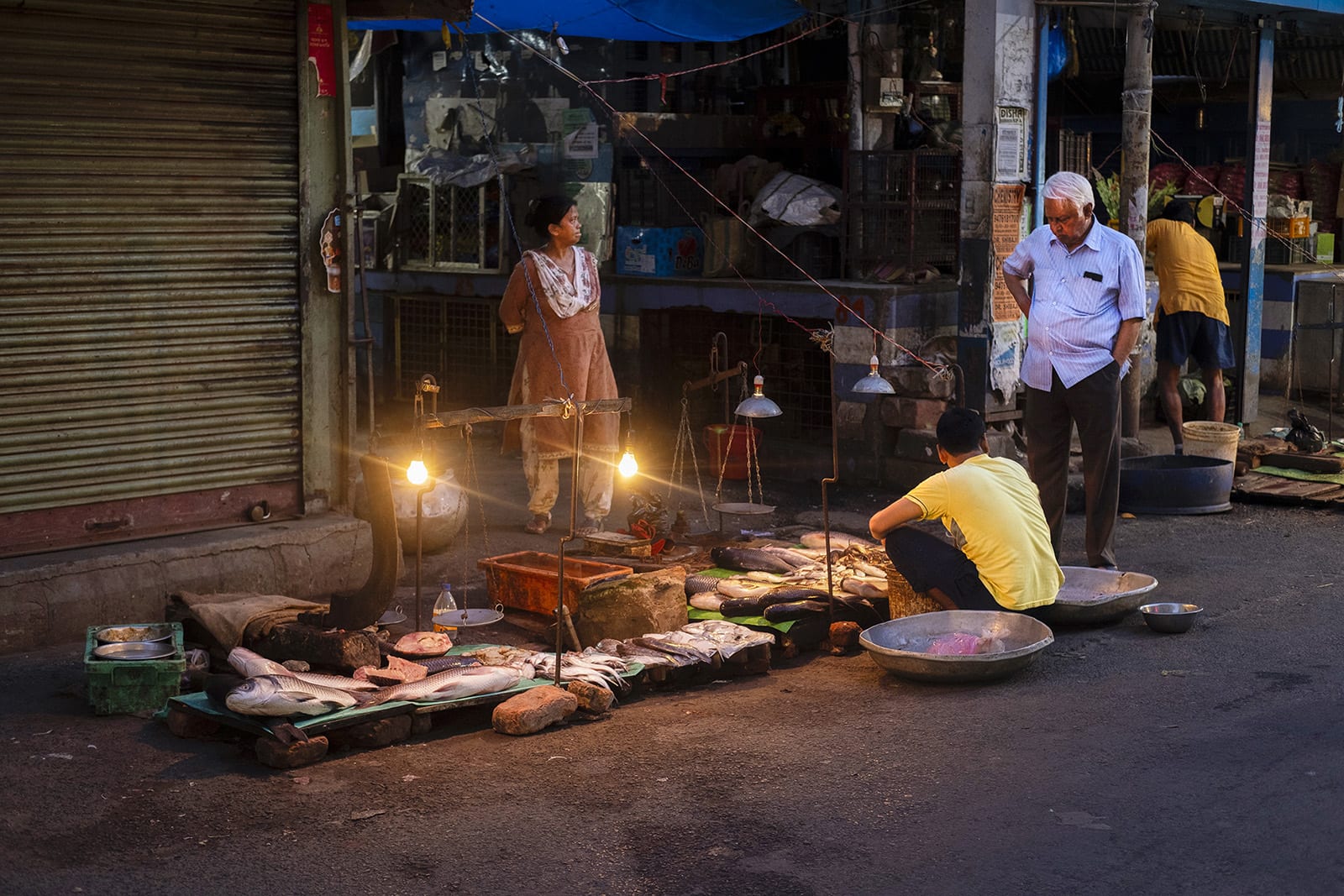 Man standing inside a fish market.