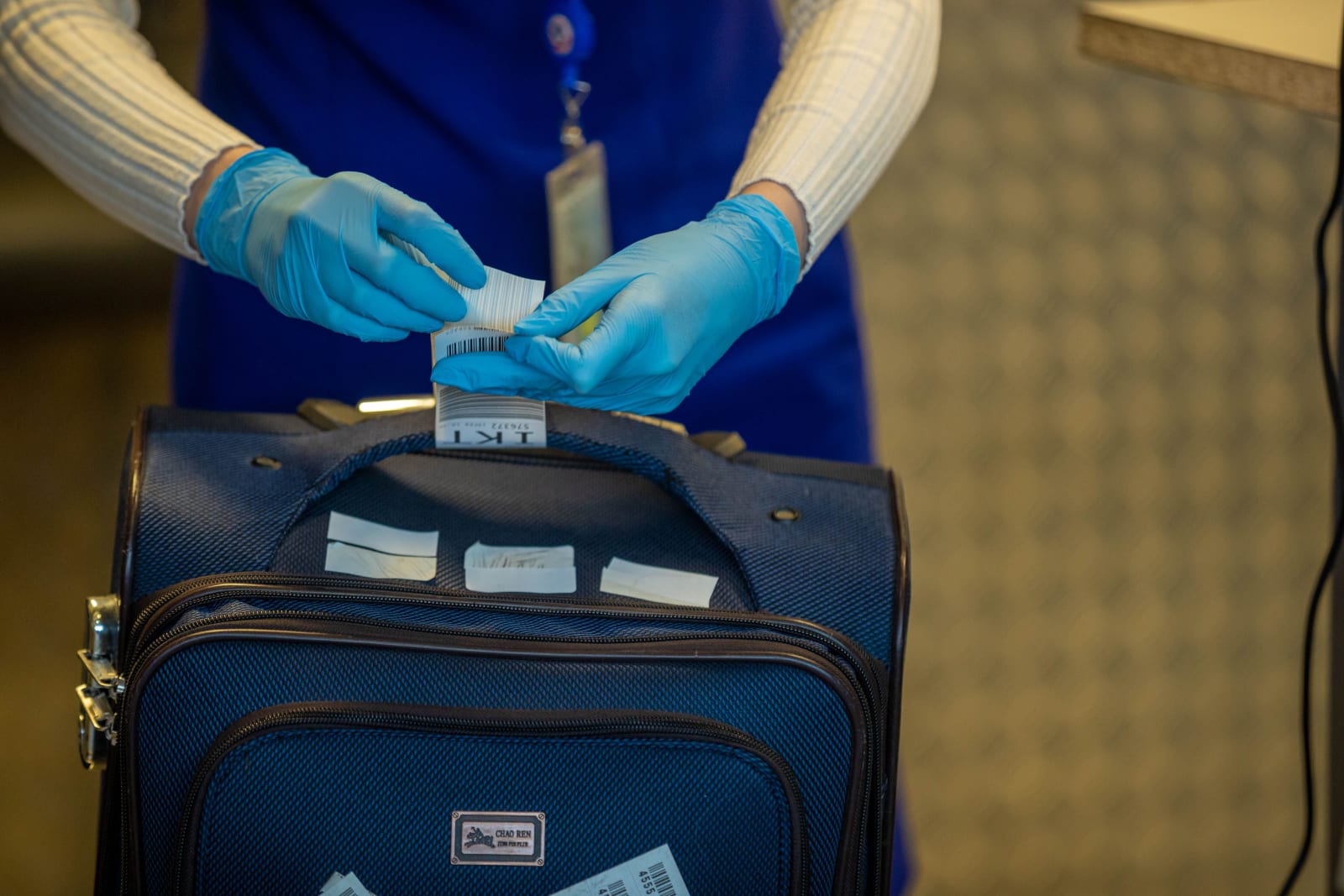 Officer checking a bag at the airport (Representative Image Source: Pexels | Photo by Sergei Starostin)