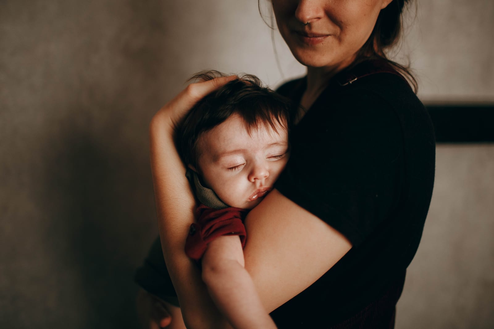 Kid sleeping in mom's arms (Representative Image Source: Pexels | Photo by Helena Lopes)