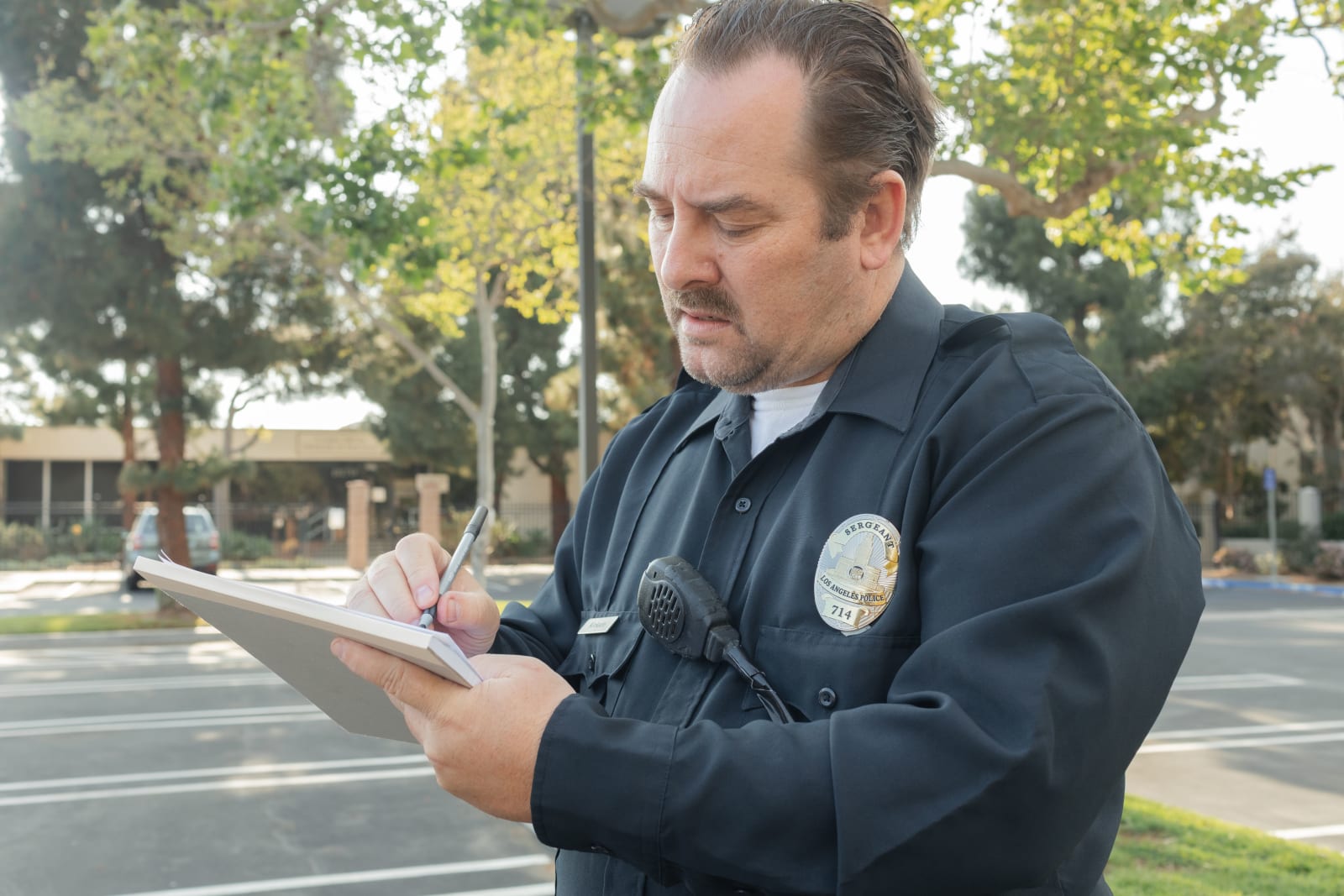 A police officer writing something in his notebook (Representative Image Source: Pexels | Photo by Kindel Media)