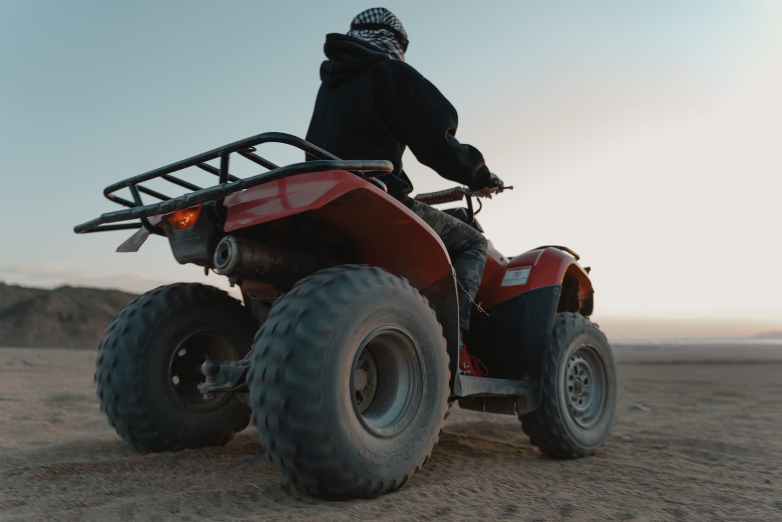 Man riding a quad bike in the desert at dawn. (Representative Cover Image Source: Pexels | Photo by Tima Miroshnichenko)