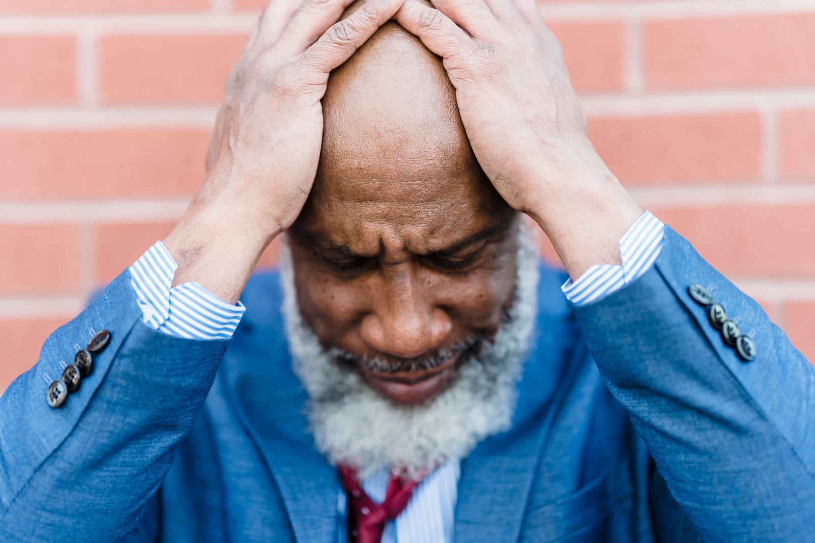 A middle-aged man in a suit showing stress