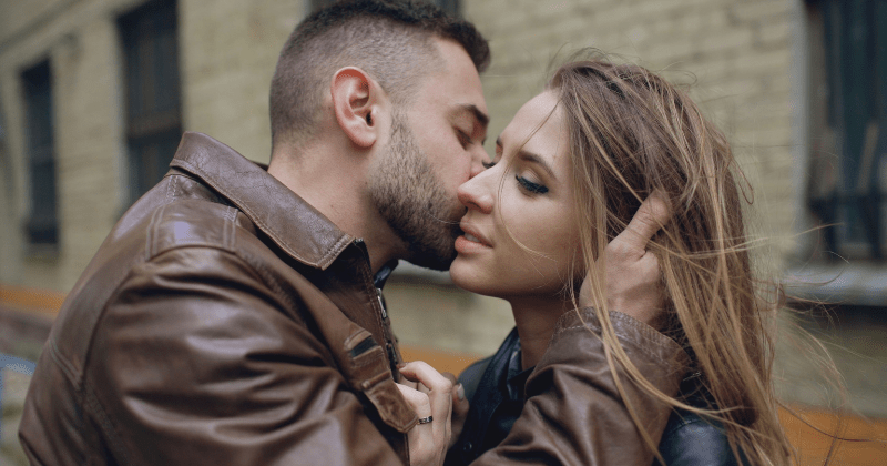 A couple shares an intimate moment outdoors with a tender embrace and a kiss (Representative Image Source: Pexels | Photo by Vitaly Gariev)