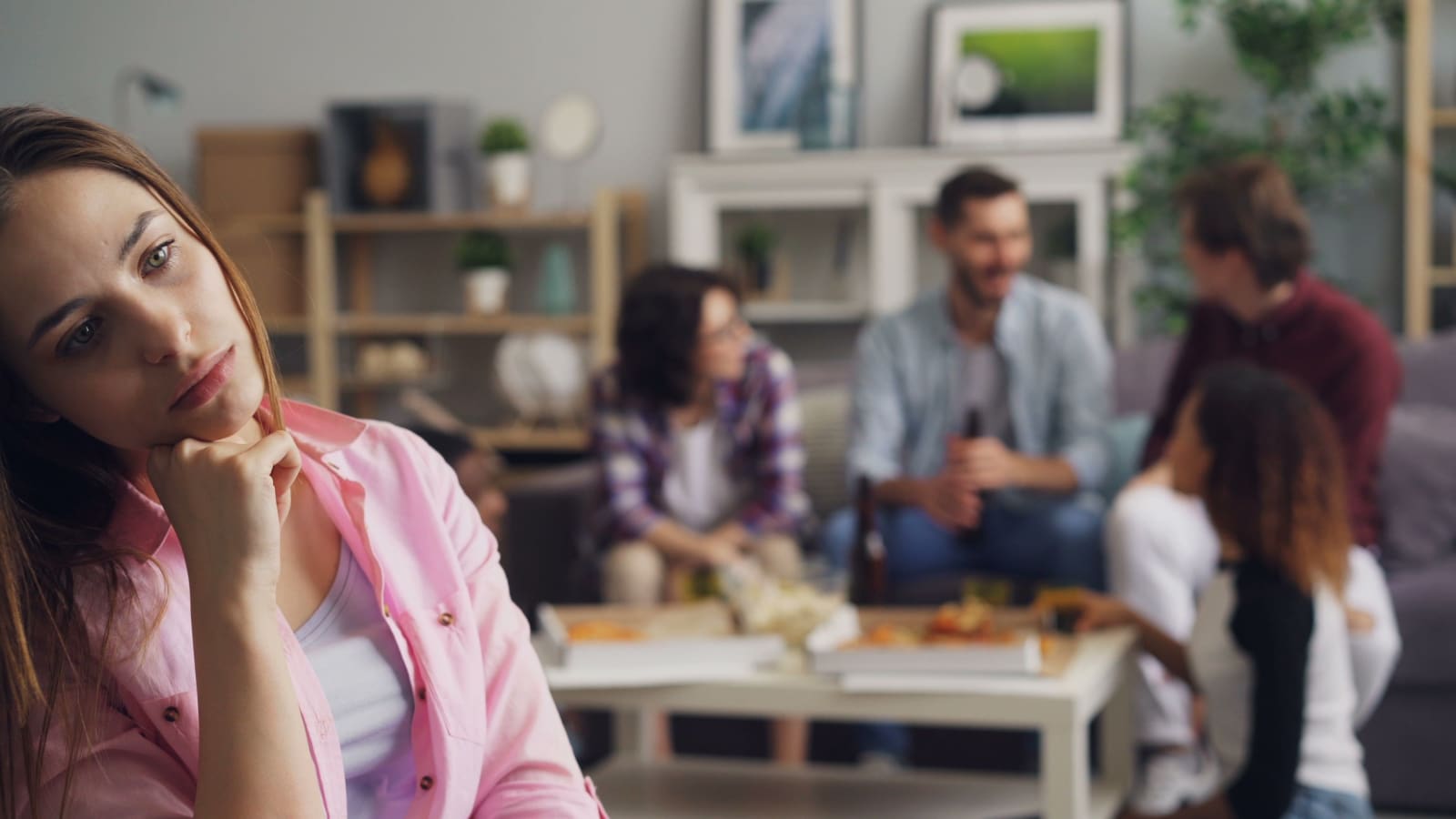 A young woman looks lonely at a party while others engage in conversation. (Representative Image Source: Pexels | Photo by Vitaly Gariev)