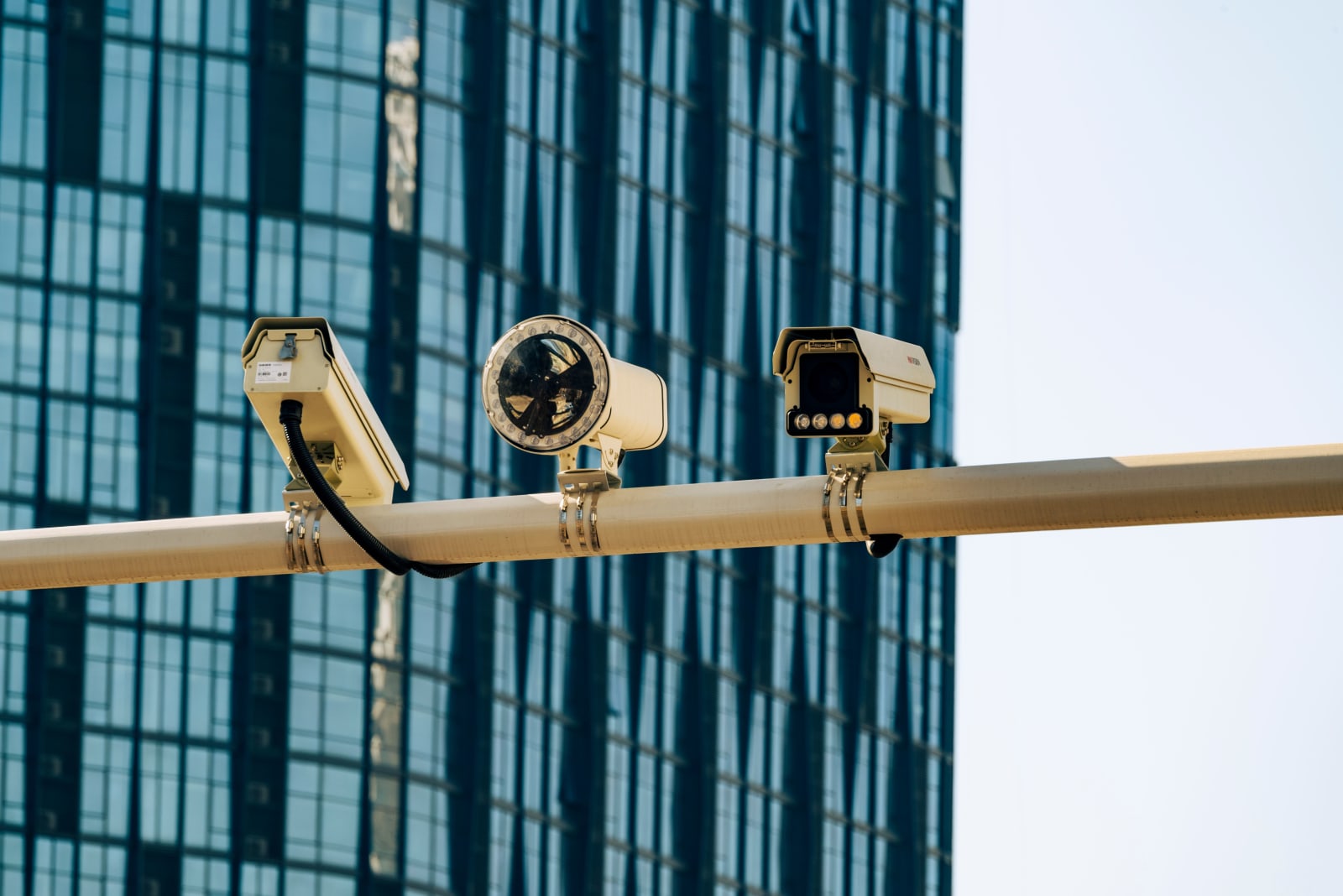 Surveillance cameras in front of a glass building (Representative Image Source: Pexels | Photo by Star Zhang)