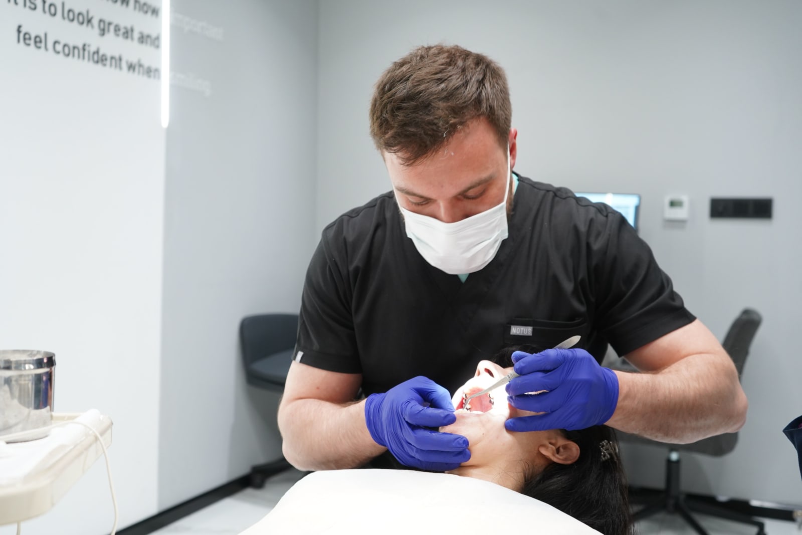 Dentist performing a dental checkup on a female patient in a modern clinic. Healthcare and dental care concept. (Representative Image Source: Pexels | Photo by Semih Demirbaş)