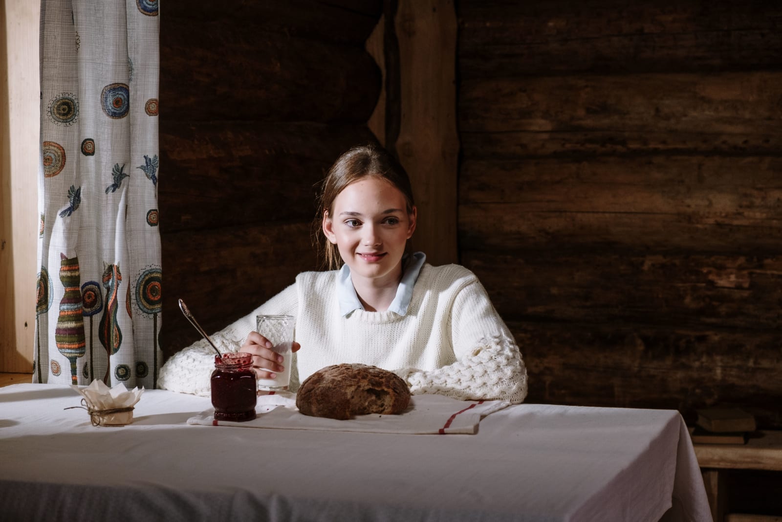 Woman with a glass of milk, a donut, and a jar of jam (Representative Image Source: Pexels | Photo by Cottonbro Studio)