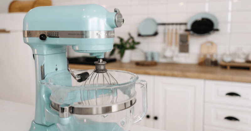 A close-up of a blue stand mixer in a sleek, modern kitchen setting (Representative Image Source: Pexels | Photo by Pavel Danilyuk)